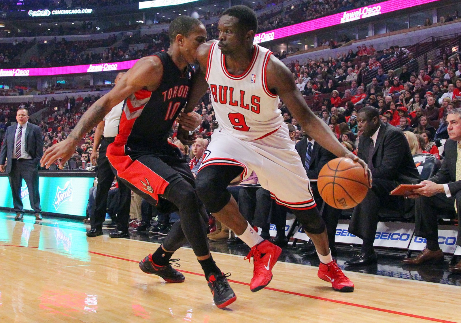 Chicago Bulls small forward Luol Deng (9) is defended by Toronto Raptors shooting guard DeMar DeRozan (10) during the first quarter at the United Center. | Dennis Wierzbicki/USA TODAY Sports 