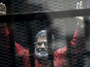 Mohammed Morsi is pictured in a defendant's cell in an Egyptian court | Ahmed Omar/AP