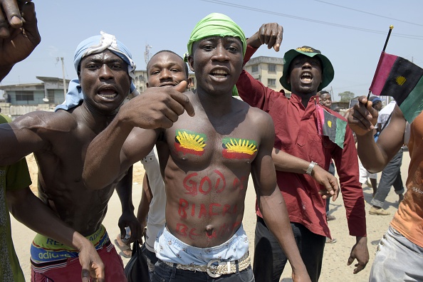 Pro-Biafra supporters shout slogans in Aba, southeastern Nigeria, during a protest calling for the release of a key activist on November 18, 2015. The protesters support the creation of a breakaway state of Biafra in the southeast and want the release of Nnamdi Kanu, who is believed to be a major sponsor of the Indigenous People of Biafra (IPOB) and director of the pirate radio station Radio Biafra. AFP PHOTO / PIUS UTOMI EKPEI        (Photo credit should read PIUS UTOMI EKPEI/AFP/Getty Images)