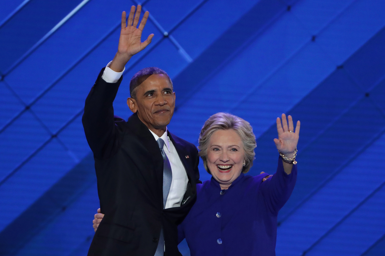 US President Barack Obama and Democratic Presidential nominee Hillary Clinton embrace on the third day of the Democratic National Convention at the Wells Fargo Center, July 27, 2016 in Philadelphia, Pennsylvania. | Alex Wong/Getty Images