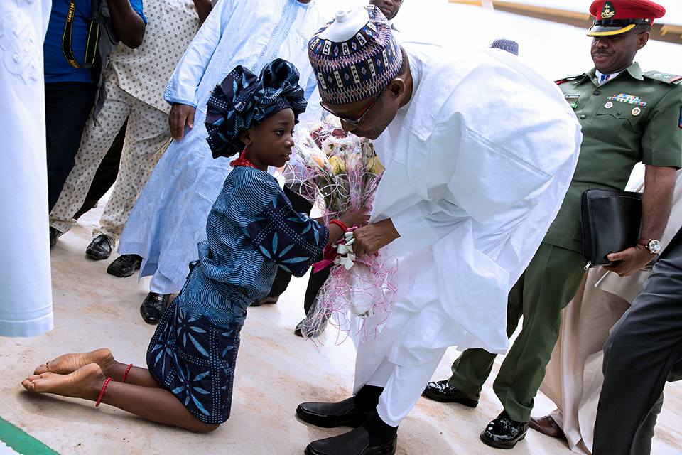 President Buhari received a flower from a girl at Osun in celebration of Osun at 25 years anniversary on 1st Sept 2016 | Femi Adesina/Facebook