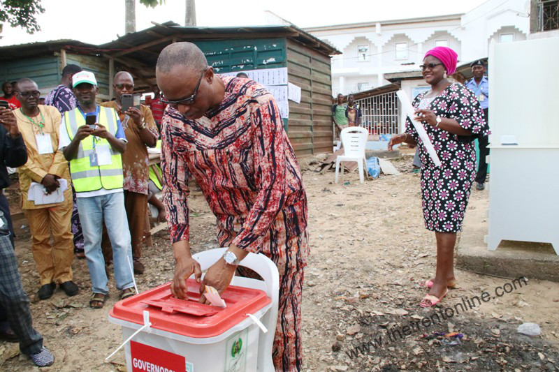 Governor Olusegun Mimiko casts his vote at Ondo West LGA in the governorship poll on Nov 26, 2016. Behind him is his wife, Oluwakemi.