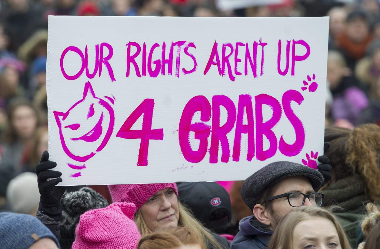 A woman holds up a sign during a demonstration to protest the inauguration of U.S. President Donald Trump in Montreal, Saturday, Jan. 21, 2017. | Graham Hughes/The Canadian Press via AP