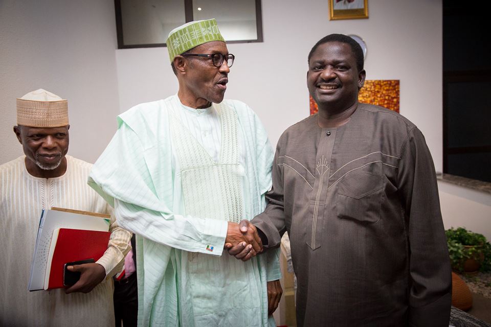 President Muhammadu Buhari (middle) shakes hands with Femi Adesina, his spokesperson