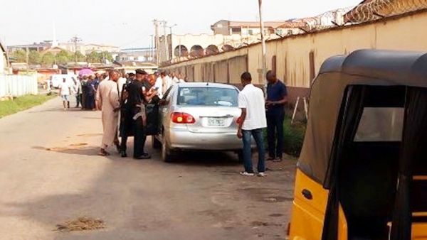 Policemen and sypathisers at the scene of the tragedy, on Sunday at Ogba, Lagos.