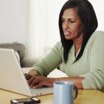 woman working desk office laptop woman light photo