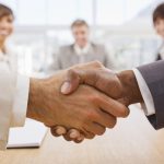 Portrait of happy businesspeople shaking hands