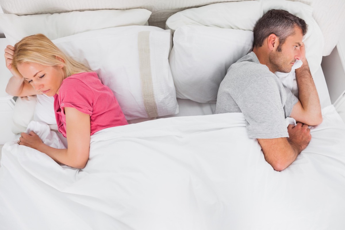 couple unhappy fighting bed