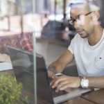 man-using-laptop-in-cafe-507832839-57b1f48b3df78cd39c1e43d5_Fotor