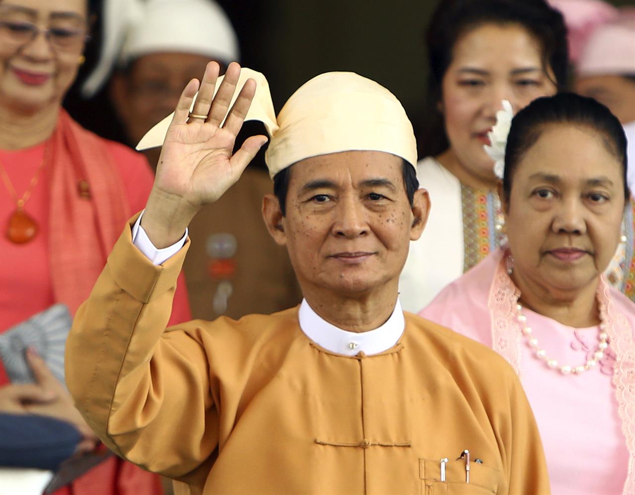 Myanmar's new President Win Myint waves to the media after taking oath of office at Parliament in Naypyitaw, Myanmar, Friday, March 30, 2018. Myanmar sworn the longtime Aung San Suu Kyi loyalist as the country's new president, who will continue his predecessor's deference to her as the nation's de facto leader. (AP Photo/Aung Shine Oo)