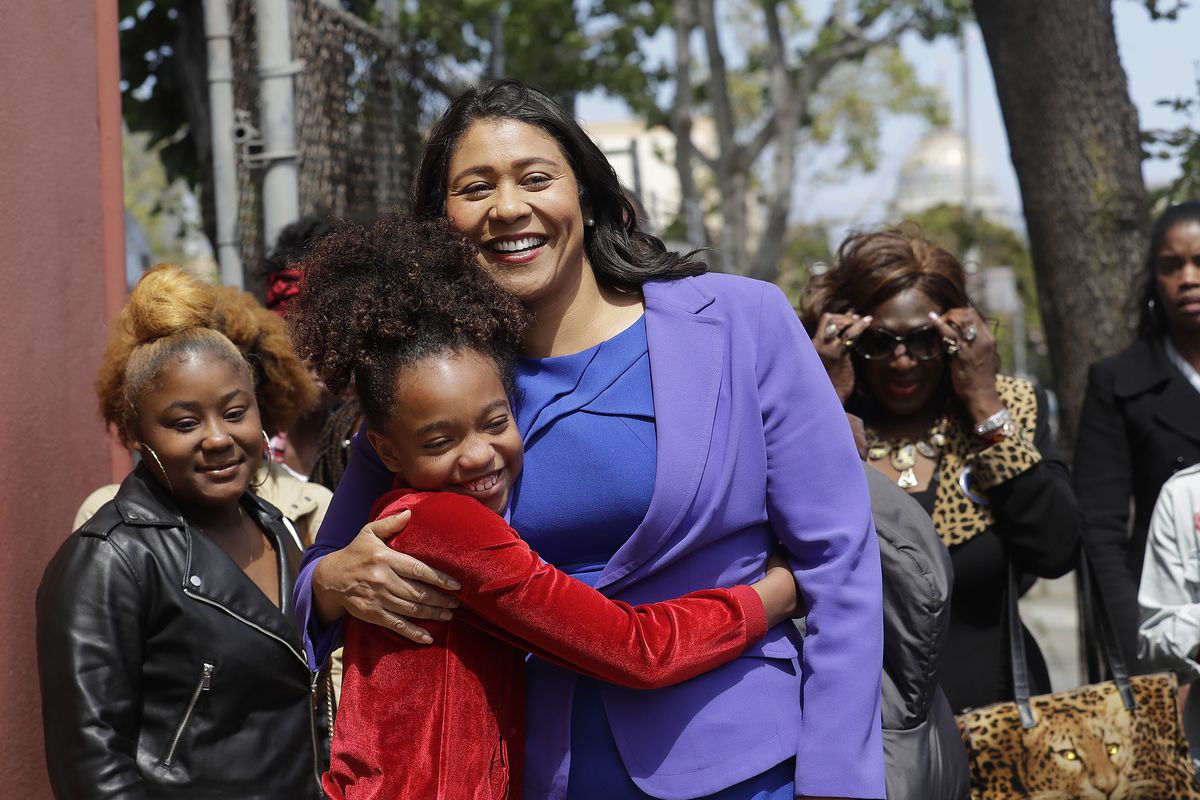 Board of Supervisors President London Breed, center, greets supporters before speaking to reporters. Photo by AP Photo/Jeff Chiu