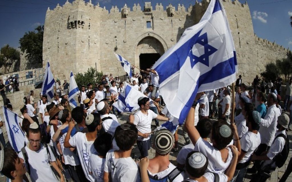 Israelis wave flags as they celebrate Jerusalem Day outside Damascus Gate in Jerusalem's Old City on May 24, 2017. (AFP PHOTO / Thomas COEX)
