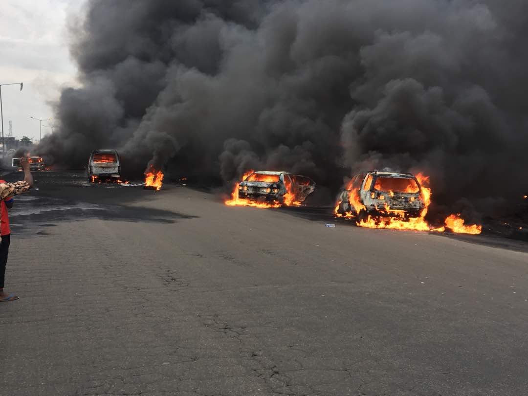 Fire burns vehicles at the scene of the tanker fire at Otedola bridge, Lagos in July 2018| NAN