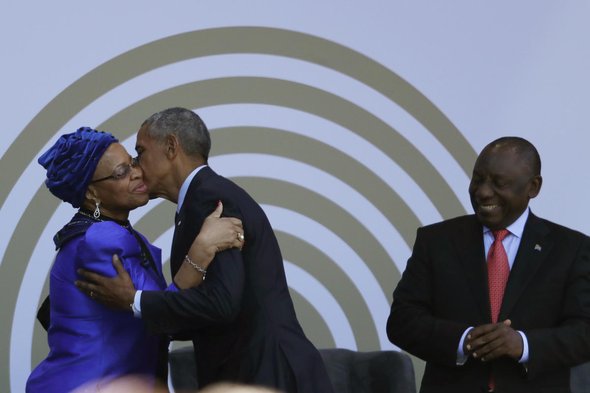 Former US president Barack Obama, centre, greets Nelson Mandela’s widow, Graca Machel (Themba Hadebe/AP)