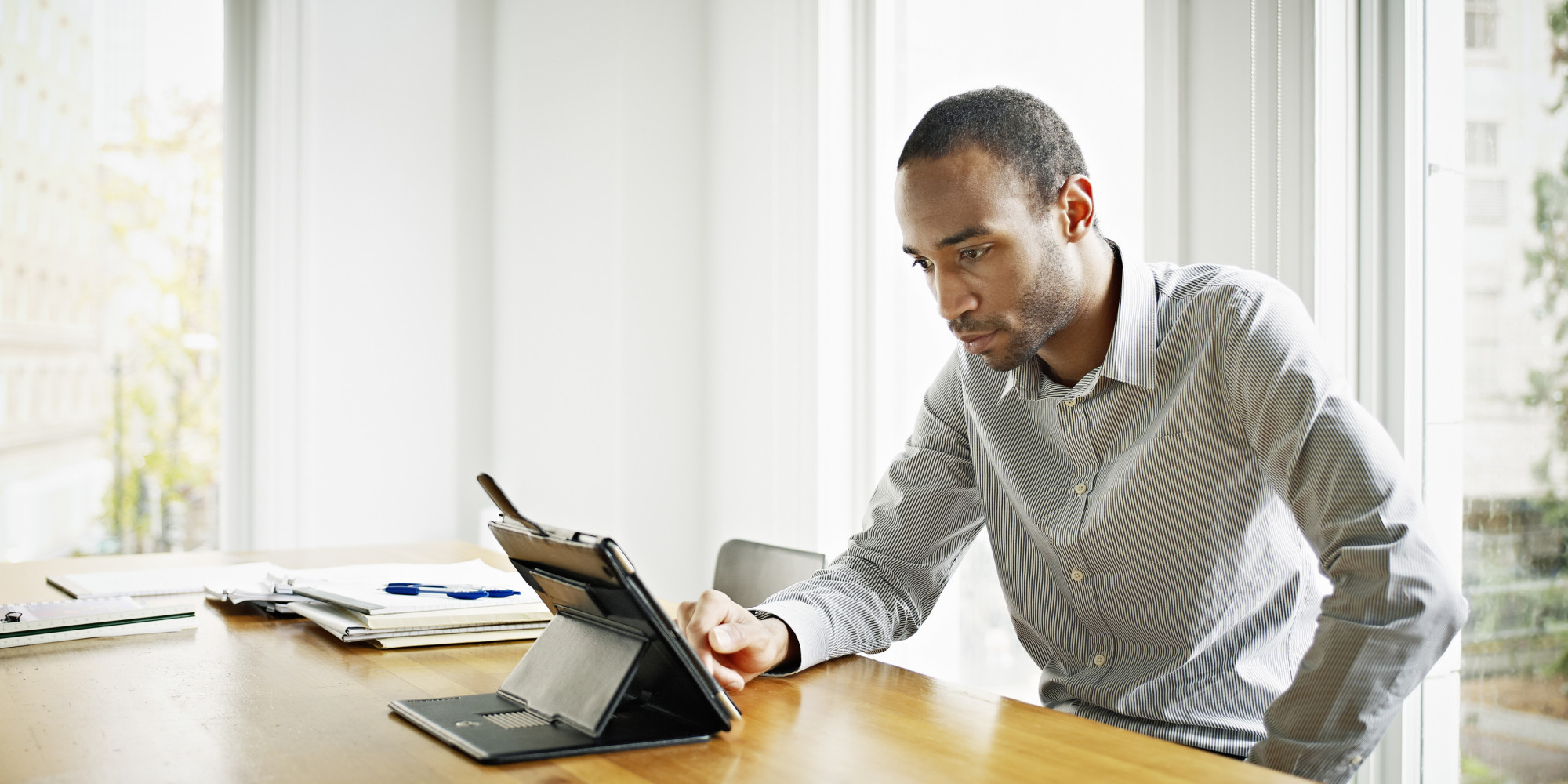 Businessman in office working on digital tablet