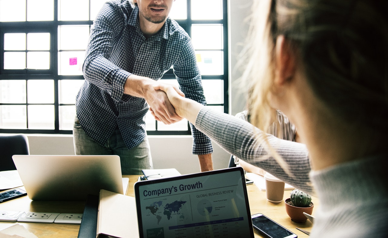 business team office handshake deal