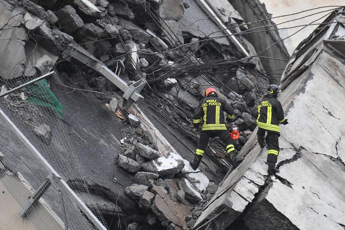 A view of the collapsed Morandi highway bridge in Genoa, Tuesday, Aug. 14, 2018. Italian authorities say that about 10 vehicles were involved when the raised highway collapsed during a sudden and violent storm in the northern port city of Genoa, while private broadcaster Sky TG24 said the collapsed section was about 200-meter long (650 feet). | Luca Zennaro/ANSA via AP