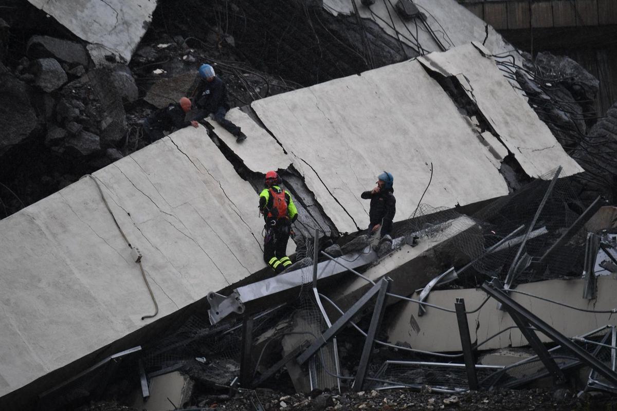 A view of the collapsed Morandi highway bridge in Genoa, Tuesday, Aug. 14, 2018. Italian authorities say that about 10 vehicles were involved when the raised highway collapsed during a sudden and violent storm in the northern port city of Genoa, while private broadcaster Sky TG24 said the collapsed section was about 200-meter long (650 feet). | Luca Zennaro/ANSA via AP