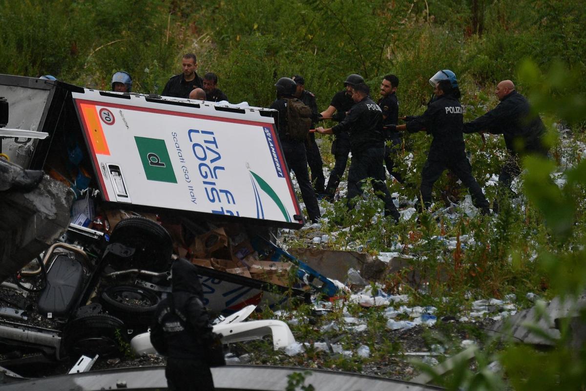 A view of the collapsed Morandi highway bridge in Genoa, Tuesday, Aug. 14, 2018. Italian authorities say that about 10 vehicles were involved when the raised highway collapsed during a sudden and violent storm in the northern port city of Genoa, while private broadcaster Sky TG24 said the collapsed section was about 200-meter long (650 feet). | Luca Zennaro/ANSA via AP