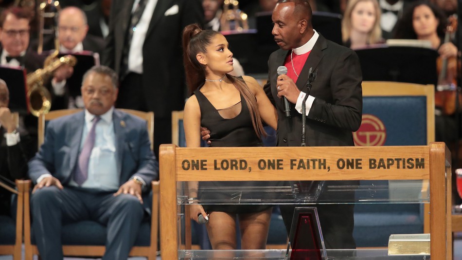 Ariana Grande with Bishop Charles Ellis III at Aretha Franklin's funeral on Friday, Aug 31, 2018 | Getty Images