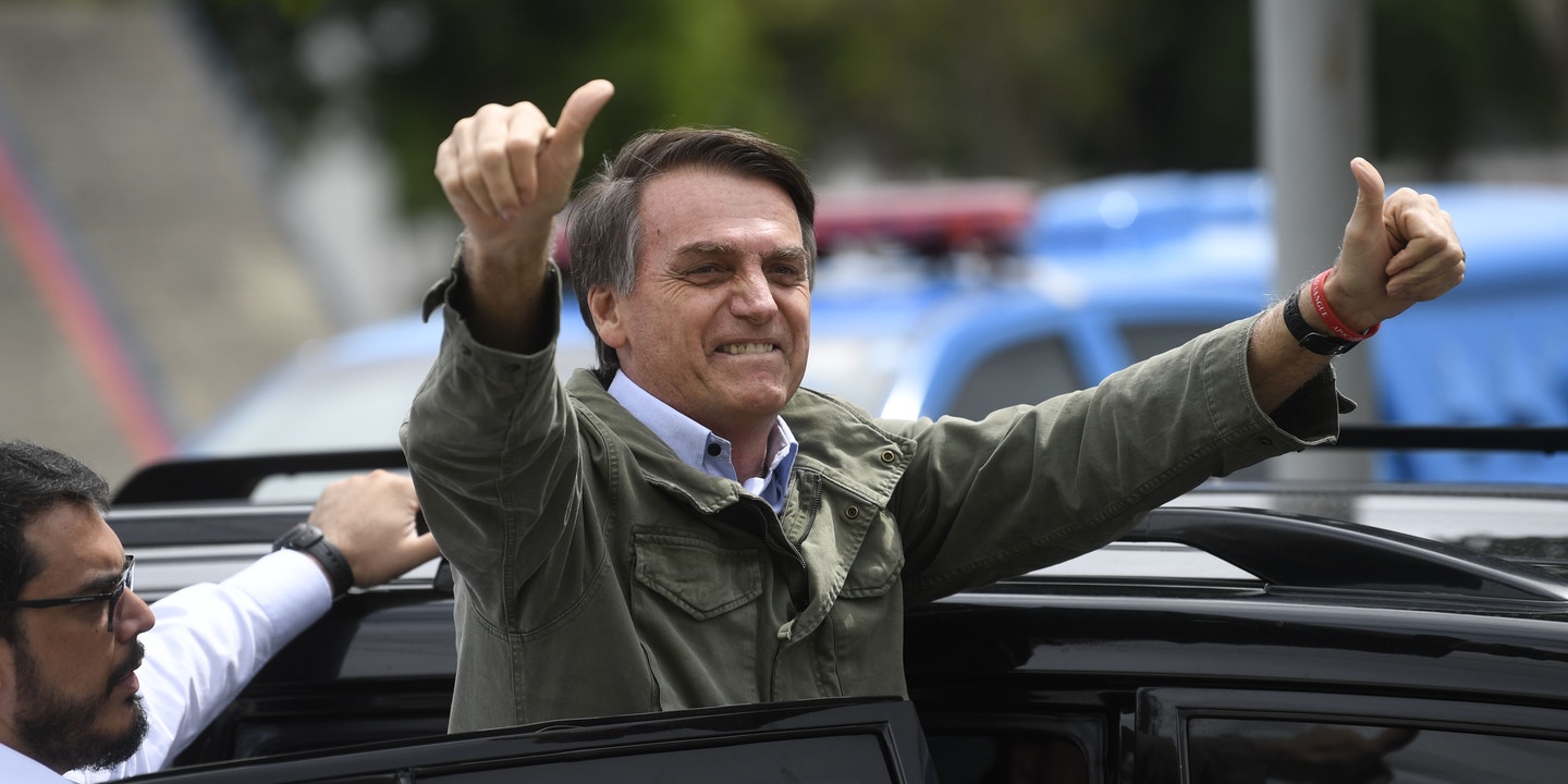 Jair Bolsonaro waves to the crowd after voting in Rio de Janeiro on October 28. Photo: Mauro Pimentel/AFP/Getty Images