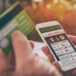 Man betting on sports with smartphone