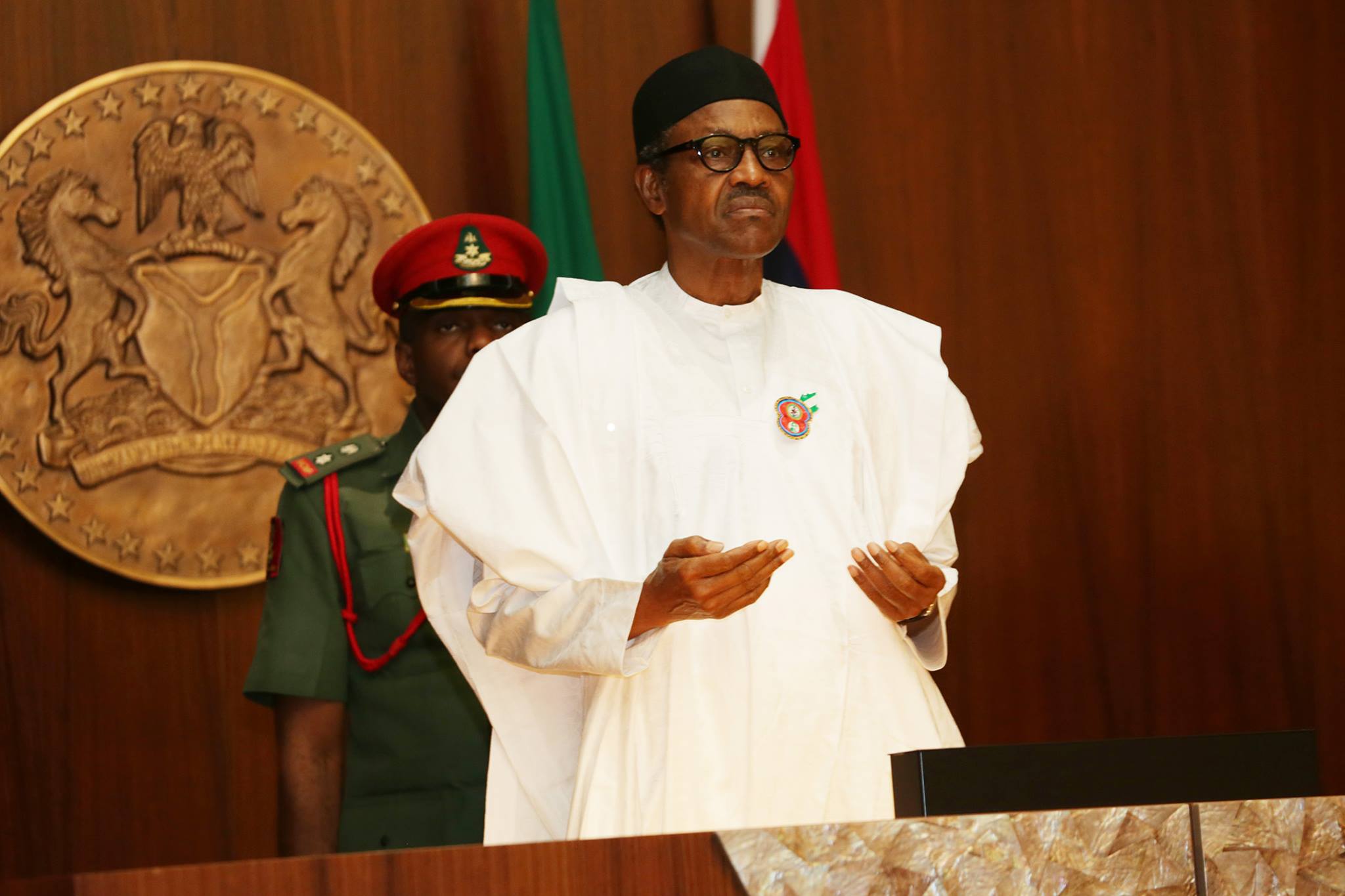kidnappers President Muhammadu Buhari prays at a Federal Executive Council Meeting
