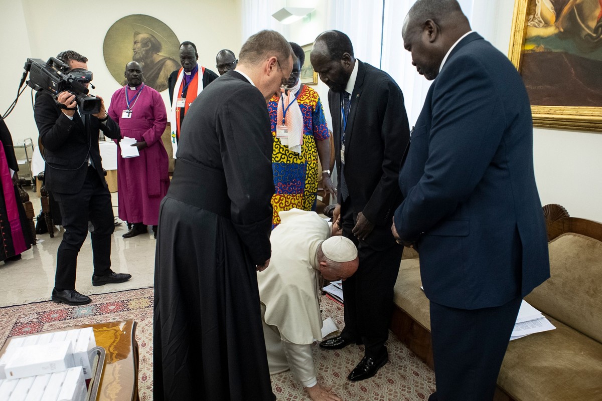 Hands Off Africa, Pope Francis kneels to kiss the feet of South Sudan's President Salva Kiir Mayardit, centre, and South Sudan opposition leader Riek Machar, right, in the Vatican.