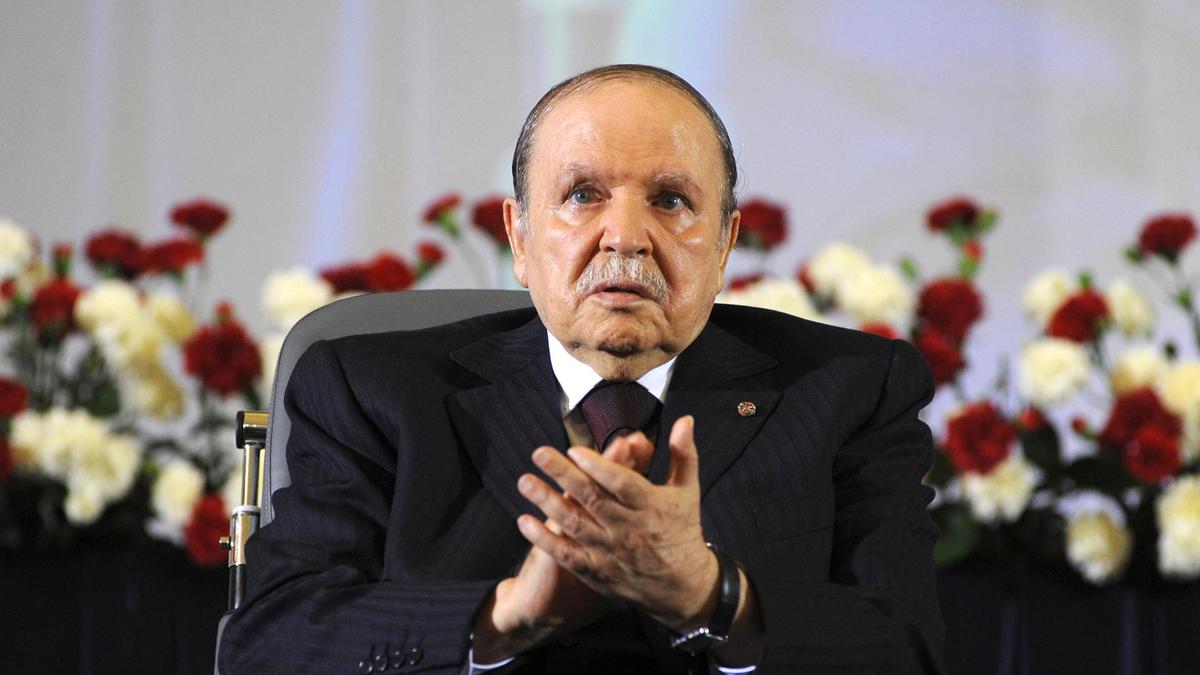 Algerian President Abdelaziz Bouteflika applauds while sitting on a wheelchair after taking oath in 2014. AP