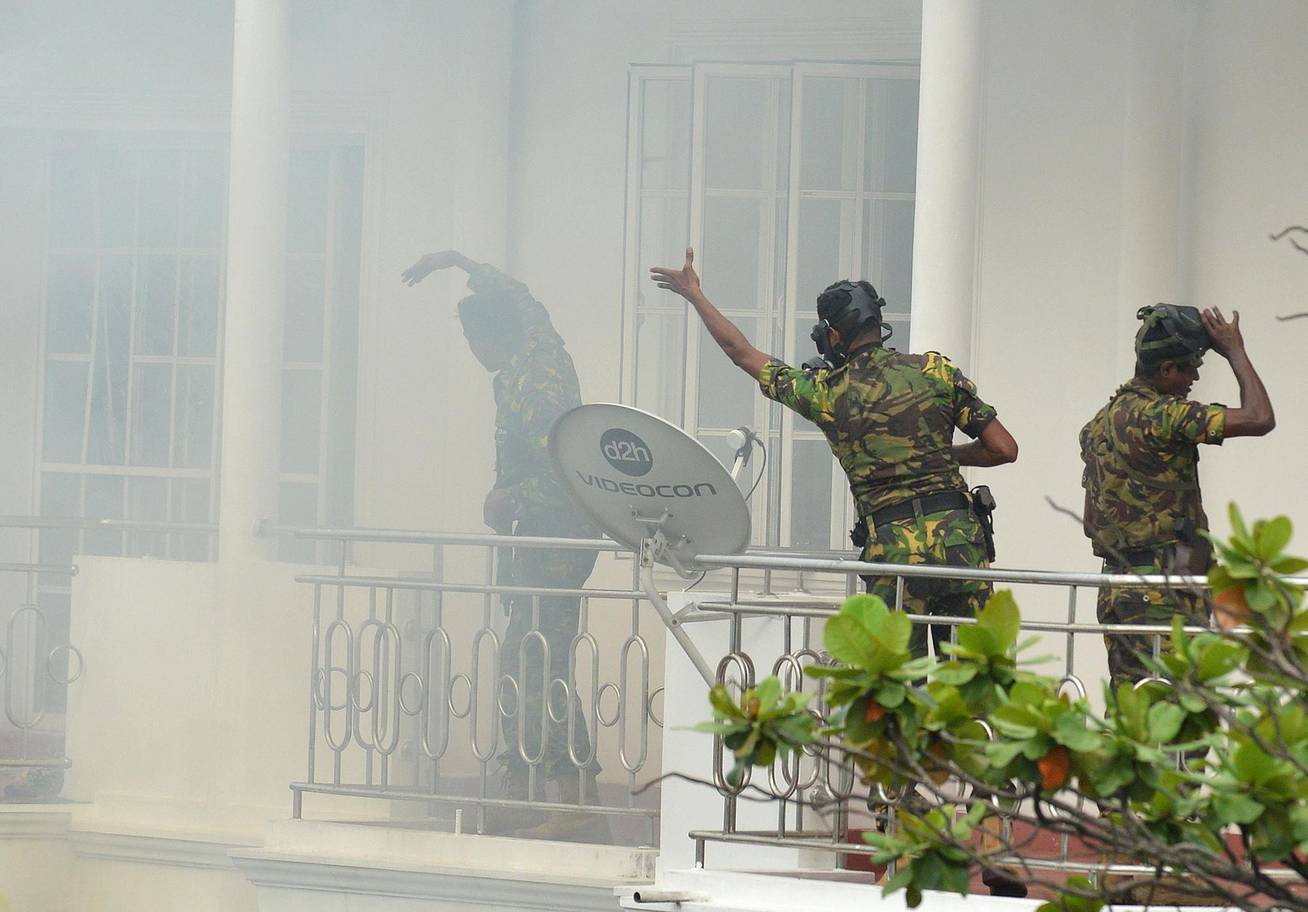 Sri Lankan Special Task Force officers raid a house following an explosion in capital Colombo AFP/Getty