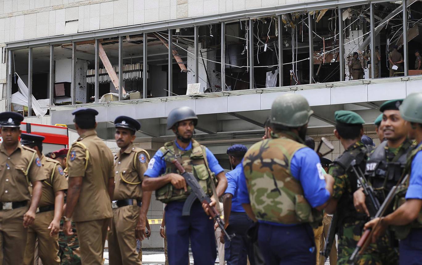 Police and security personnel stand guard outside the Shangri-La Hotel in Sri Lankan capital Colombo following a bombing attack EPA