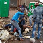 Mozambique national Emmanuel Sithole is attacked by men in Alexandra township during the anti-immigrant violence  in Johannesburg