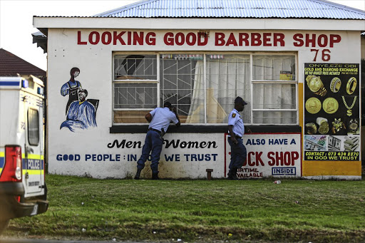 Police look for clues outside the premises where five teenage girls were found in 2017. Image: MOELETSI MABE/TimesLIVE