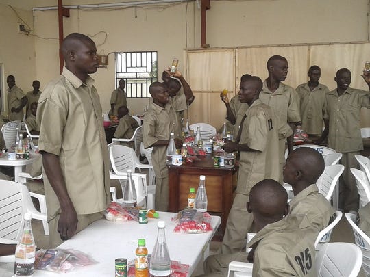 Repentant Boko Haram militants receive breakfast before being loaded onto an aircraft by the Nigerian military prior to being taken to a rehabilitation centre in Gombe. (Photo: Usuf Osman, European Press photo Agency)