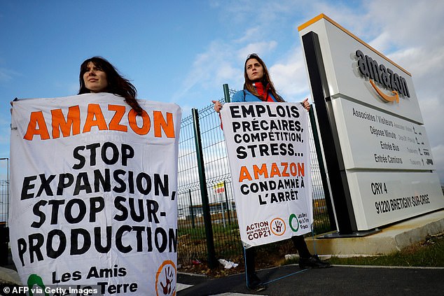 Friends of the Earth activists block an Amazon centre in Bretigny-sur-Orge on Thursday to protest the company's impact on climate change