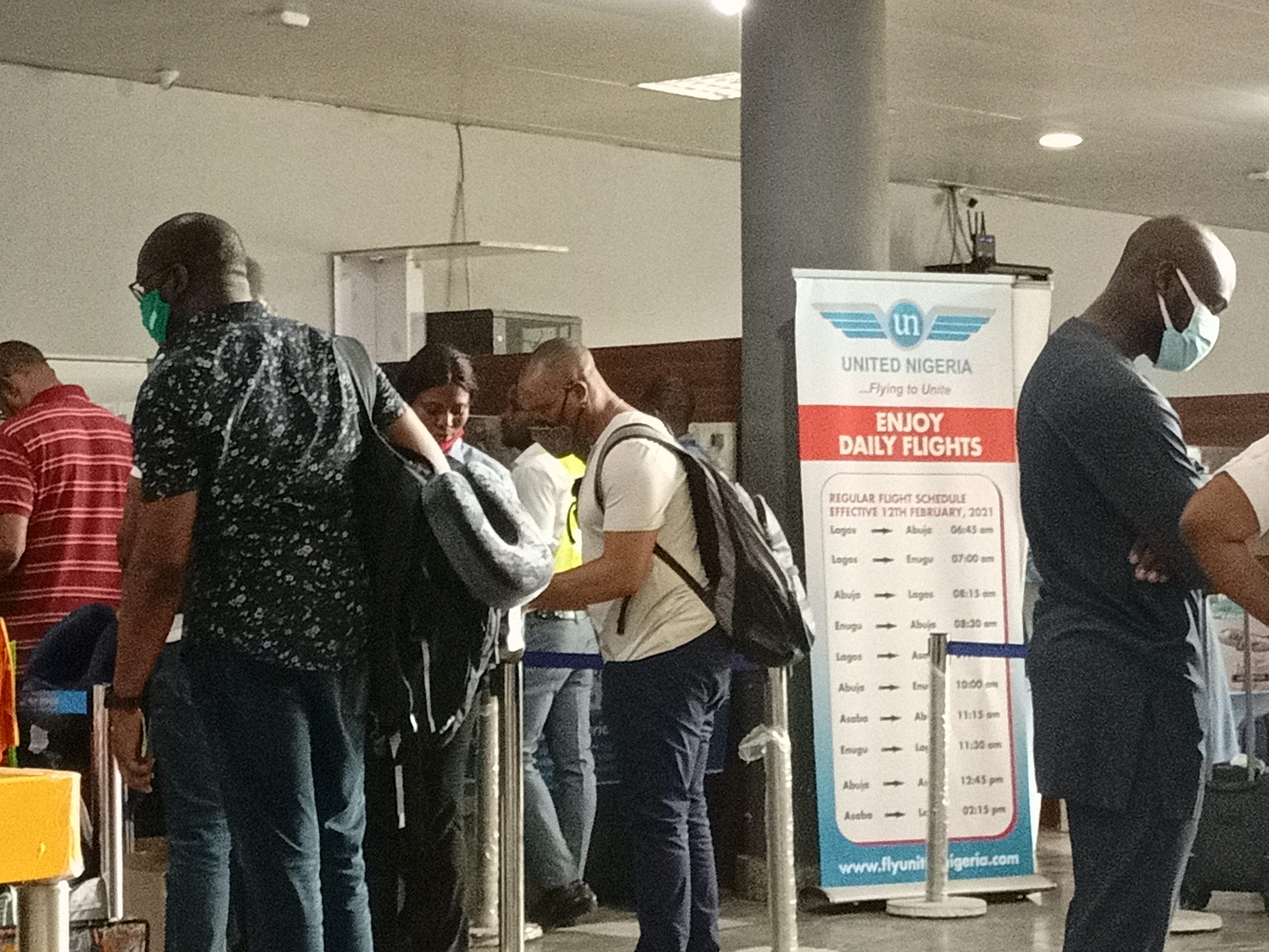 United Nigeria Airlines passengers rushing for Air Peace tickets after being forced to disembark following battery failure of their flight to Lagos from Asaba Airport on June 28, 2021. | The Trent Photo