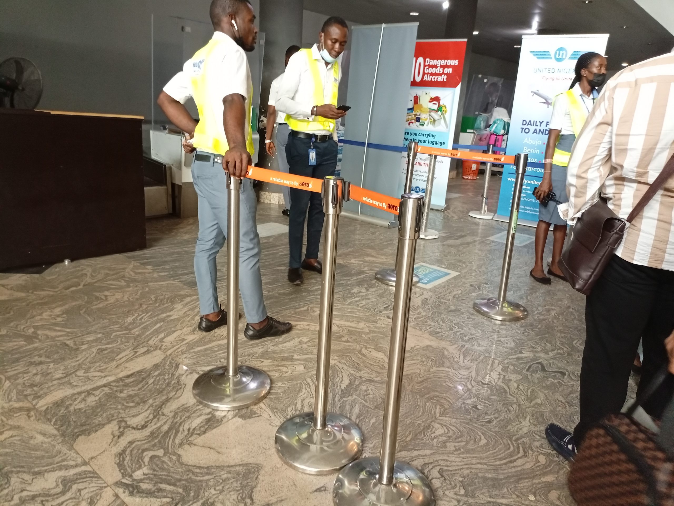 United Nigeria Airlines passengers besiege the airline's counter after being forced to disembark following battery failure of their flight to Lagos from Asaba Airport on June 28, 2021. | The Trent Photo