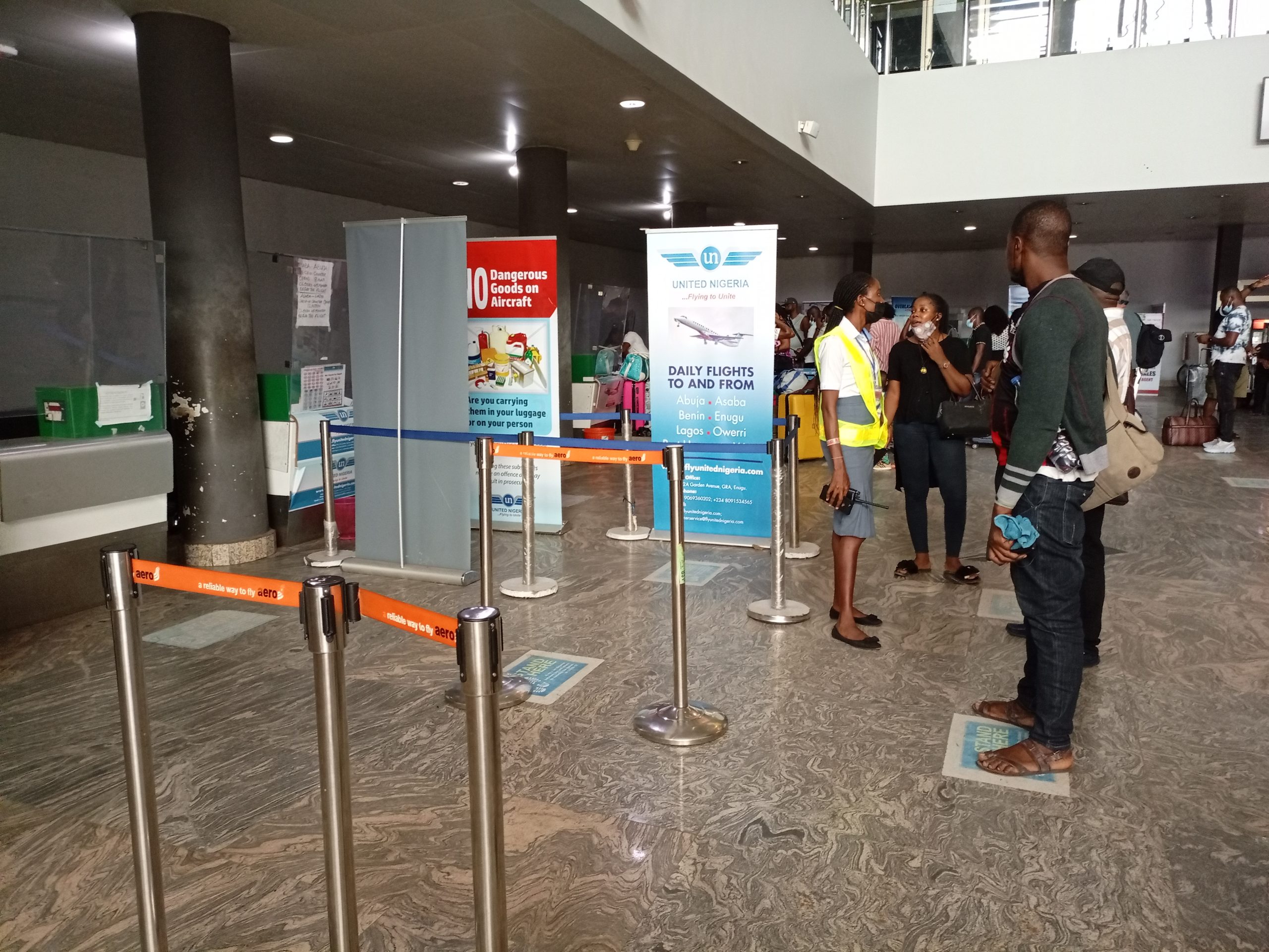 United Nigeria Airlines passengers besiege the airline's counter after being forced to disembark following battery failure of their flight to Lagos from Asaba Airport on June 28, 2021. | The Trent Photo