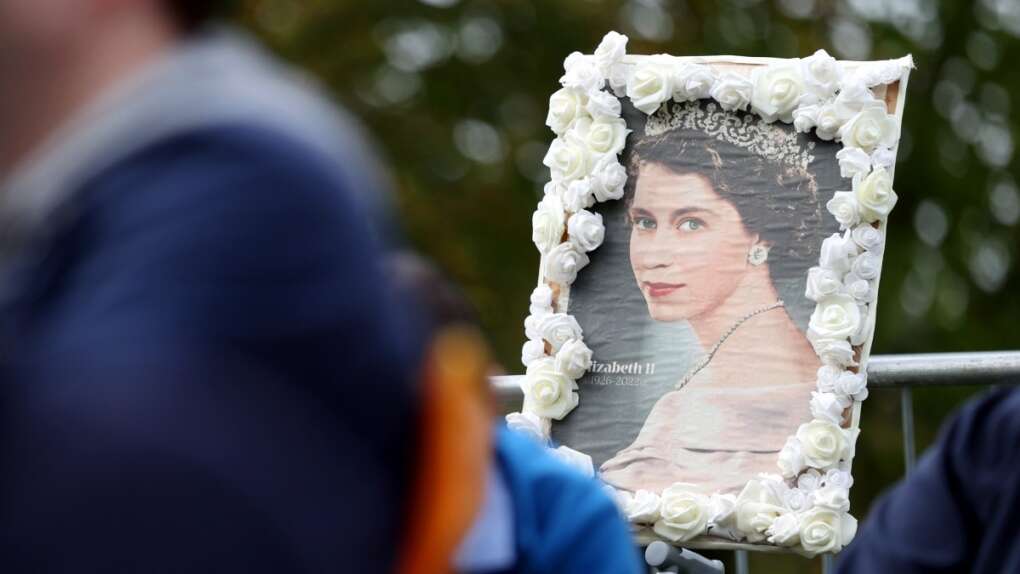 A picture of Queen Elizabeth II is decorated with flowers before the committal service at St George's Chapel, in Windsor, England, Sept. 19, 2022. (Alex Pantling/Pool photo via AP)