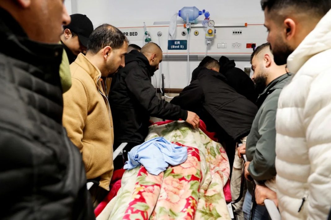 Israeli special forces, Mourners grieve next to the body of a Palestinian man killed in the raid when Israeli commandos in disguise carrying assault weapons as they raided the Ibn Sina hospital in Jenin, January 30, 2024.