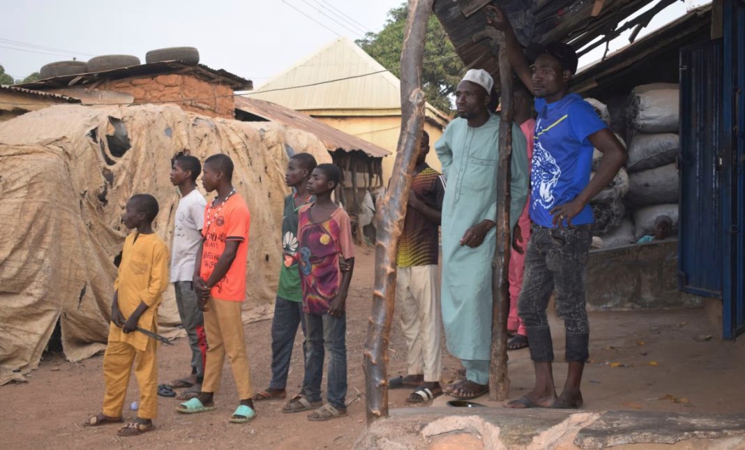 People gather around an area were gunmen kidnapped school children in Chikun, Nigeria. | AP Photo