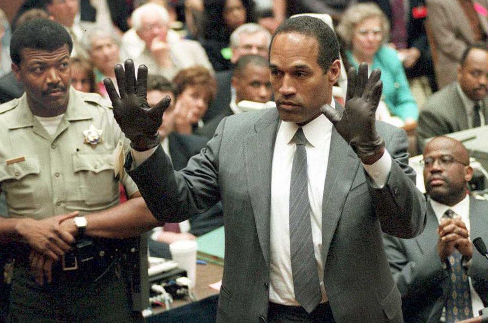 O.J. Simpson shows the jury a new pair of Aris extra-large gloves, similar to the gloves found at the crime scene 21 June 1995, during his double murder trial in Los Angeles, CA.VINCE BUCCI/AFP via Getty Images
