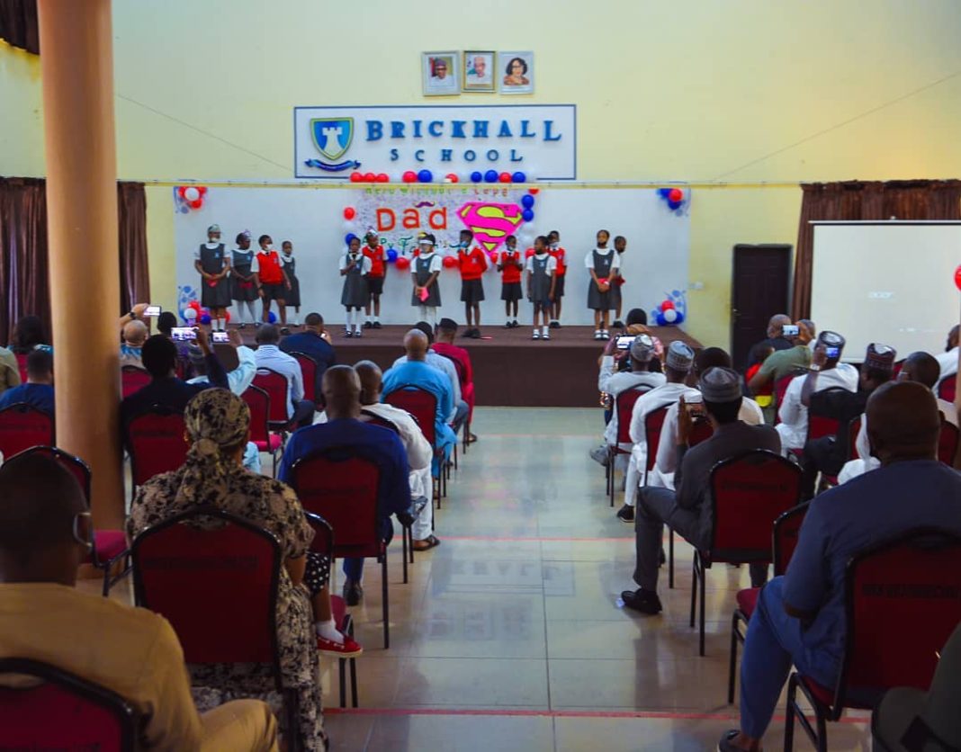 Pupils make a presentation at the Brickhall School hall on Father's Day in 2021. | Facebook