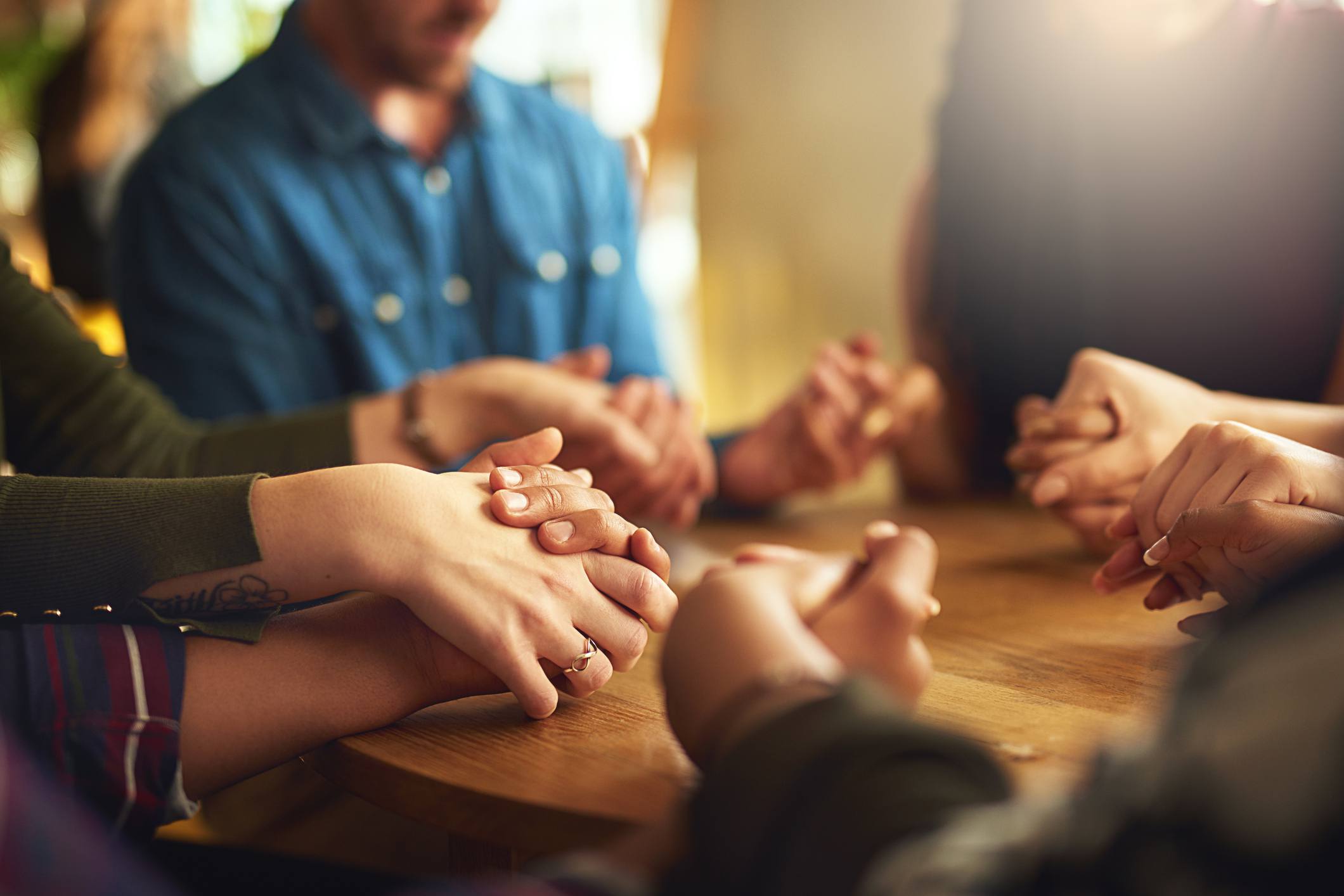 young man praying, prayer, group prayer, prayer circle