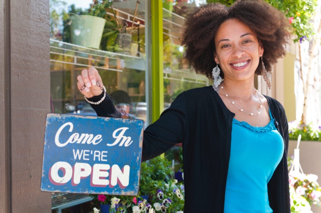 creativity-in-business, starting a business, business, A black male waiter is standing and holding the tablet and friendly smiling for the wait to welcome customers in the restaurant.
