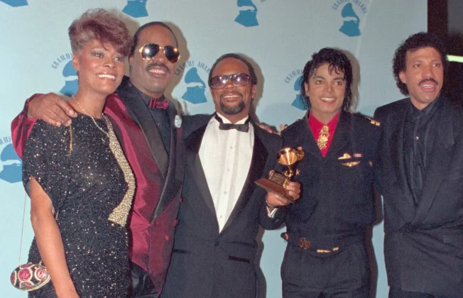 Warwick, Stevie Wonder, Jones, Jackson and Lionel Ritchie pose with the Grammy they received for their performances on the all-star recording USA for Africa: We Are the World, 1985. Jones produced and conducted the celebrities and wrote a sign ‘Check your egos at the door’ on the front door of A&M Studios in Los Angeles. | Bettmann Archive