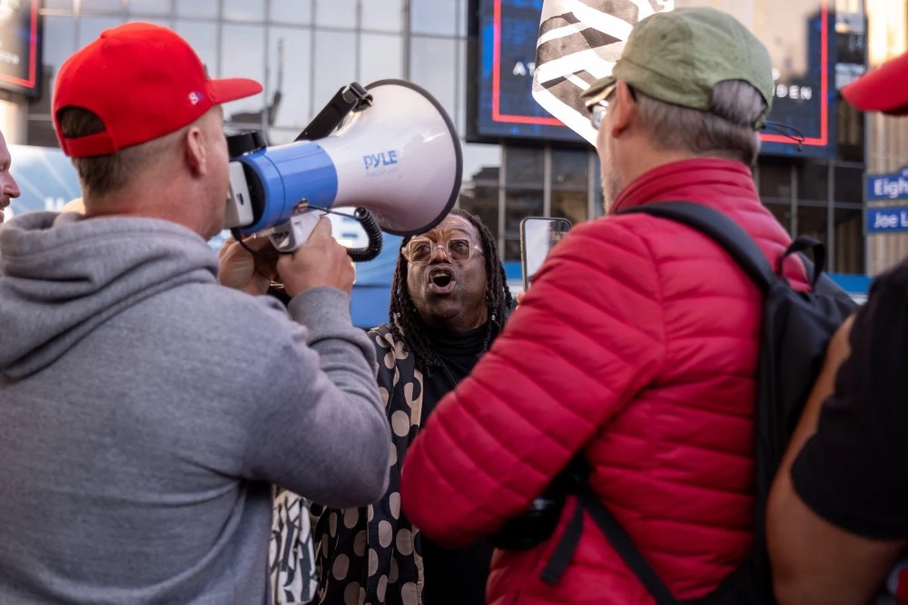 A man argues with Donald Trump supporters outside a rally at New York's Madison Square Garden on Oct. 27. Merriam-Webster announced Monday that its 2024 Word of the Year is 