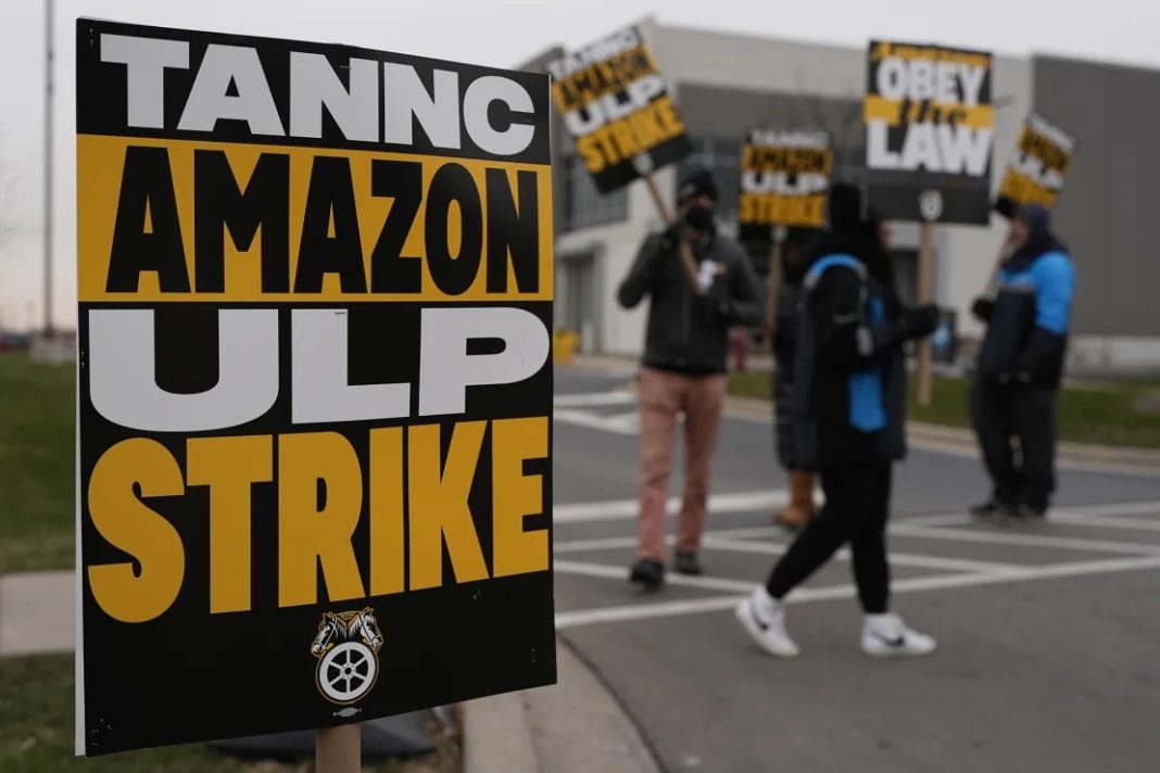 Strikers hold signs during a strike at Skokie (DIL7) Amazon Delivery station in Skokie, Illinois, on December 19, 2024. | Nam Y. Huh/AP