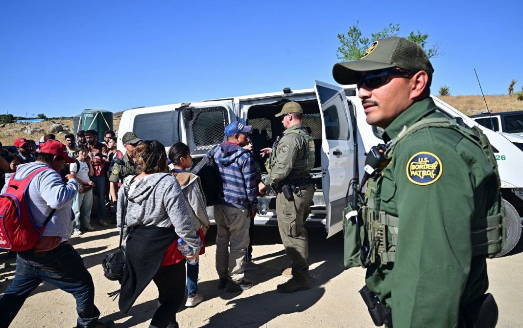 Mexico Embraces You, Customs and Border Patrol agents load migrants into a vehicle in Jacumba Hot Springs, California in June 2024. | Frederic J. Brown/AFP/Getty Images