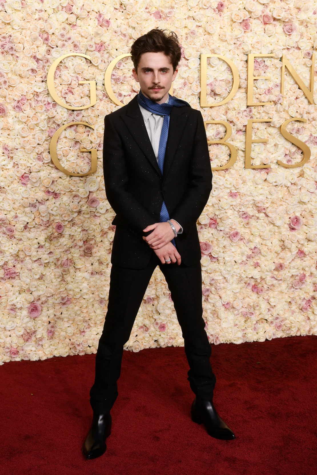 Timothée Chalamet, wearing Tom Ford, styled his necktie like a scarf at the 82nd Golden Globes Awards held at the Beverly Hills Hotel, Beverly Hills, California on Sunday, January 5, 2025. | Etienne Laurent/AFP/Getty Images